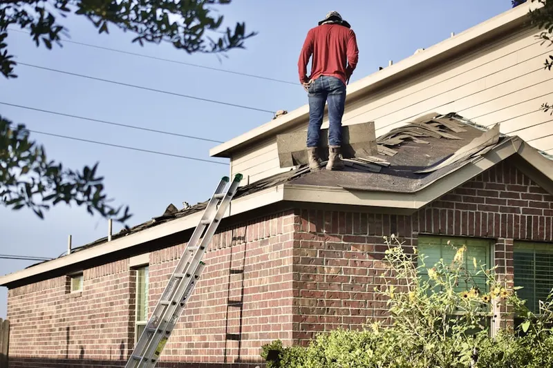 Professional roofer working on a residential roof in South Davis Shores